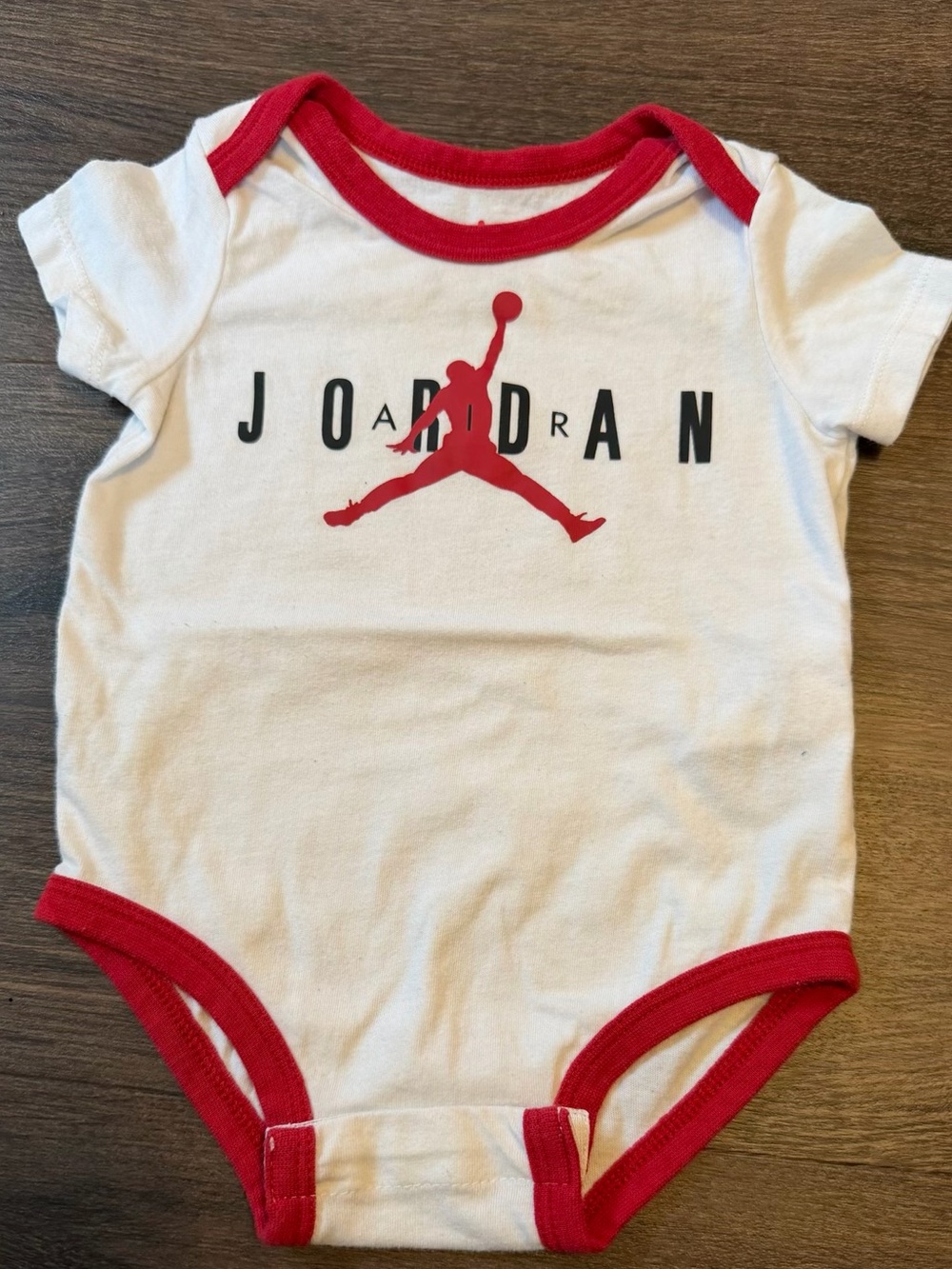 Jordan White Baby Bodysuit with Red Trim and Black Lettering